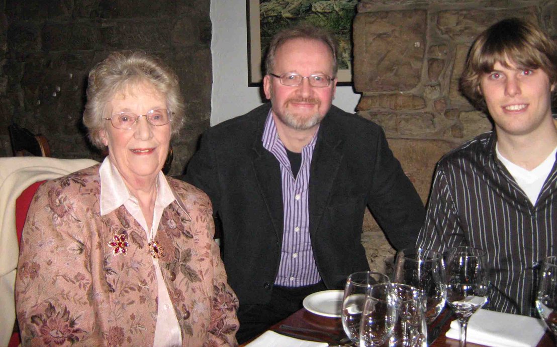 Alma, Peter and Guy sitting at a restaurant table after a meal