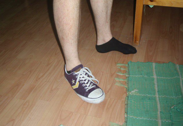 Guy's feet, only one has a shoe