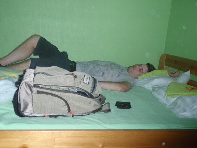 Guy passed out at the hostel with a partially packed bag alongside